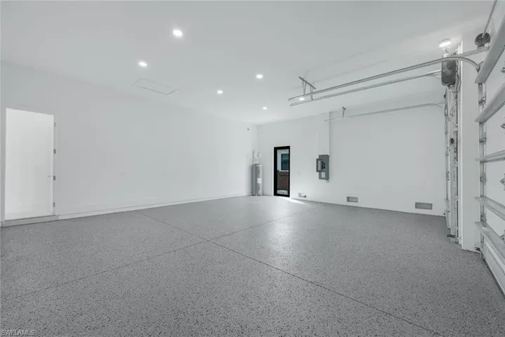 Garage with water heater and recessed lighting