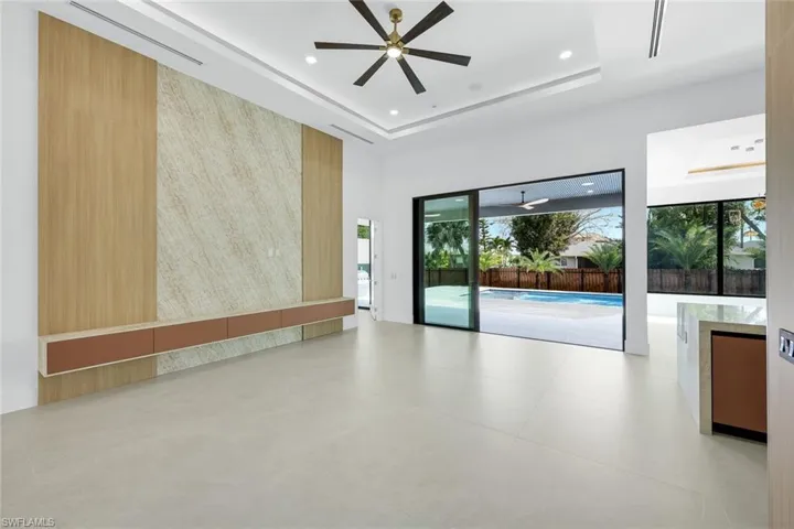 Empty room featuring ceiling fan, recessed lighting, and a raised ceiling