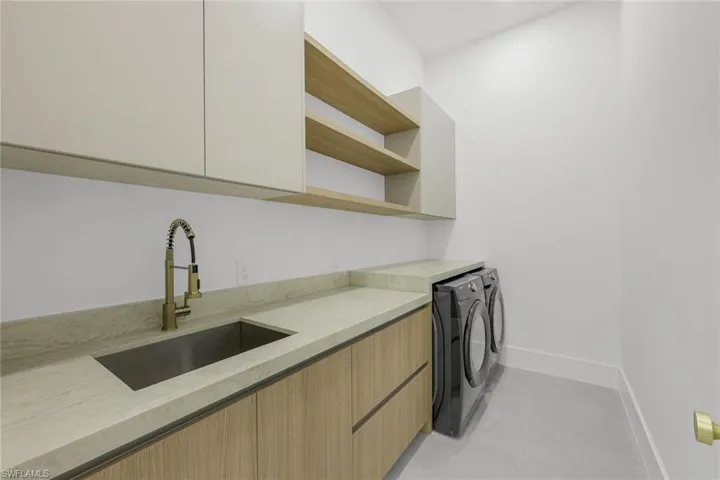 Laundry area with washer and clothes dryer and cabinet space