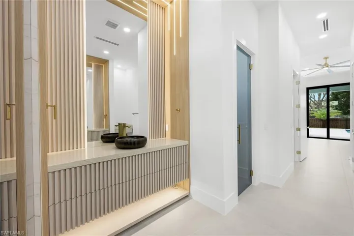 Bathroom featuring vanity, recessed lighting, and ceiling fan