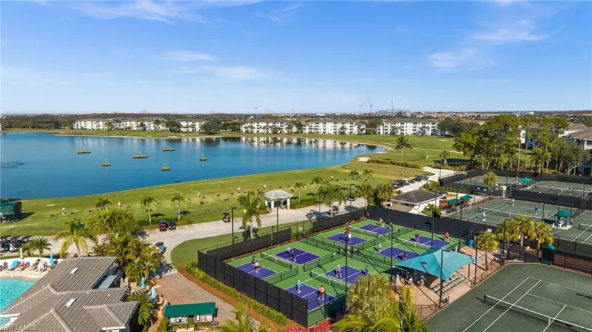 Drone / aerial view of a nearby body of water and apartment complex