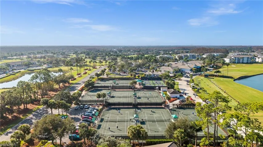 Drone / aerial view of a nearby body of water and a local golf course