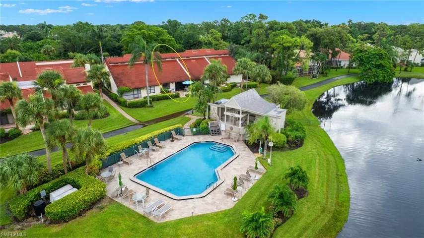 View of pool with a yard, a patio area, and lake view