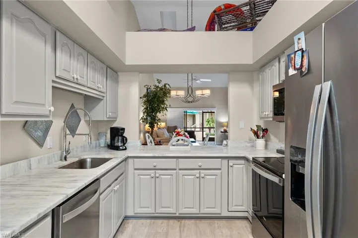 Kitchen featuring stone countertops, and kitchen peninsula
