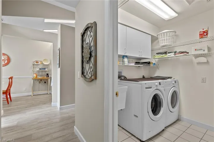 Washer and dryer,  cabinets and plenty of shelving