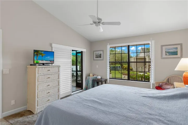 Bedroom with ceiling fan, high vaulted ceiling, and access to exterior, lake view