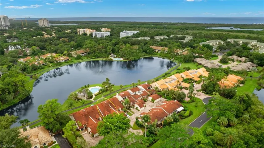 Birds eye view of property with lake view