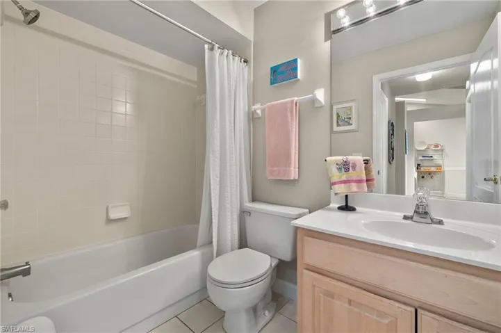 Full bathroom featuring tile patterned floors, vanity, shower / tub combo, and toilet