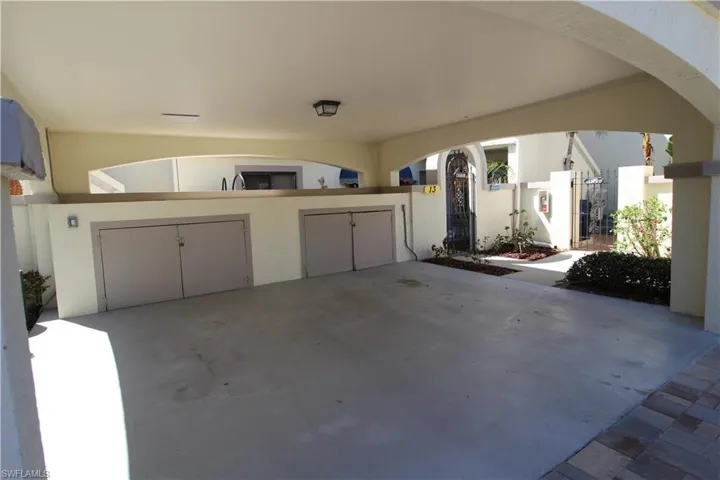 Unit carport on the left w/ private storage space