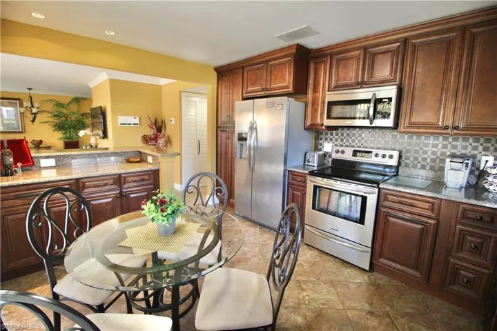 Kitchen with stainless steel appliances, tons of cabinets, granite countertops
