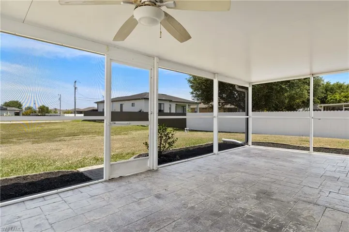 Unfurnished sunroom with a wealth of natural light and a ceiling fan