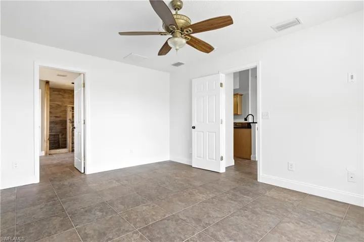 Unfurnished bedroom featuring visible vents and baseboards