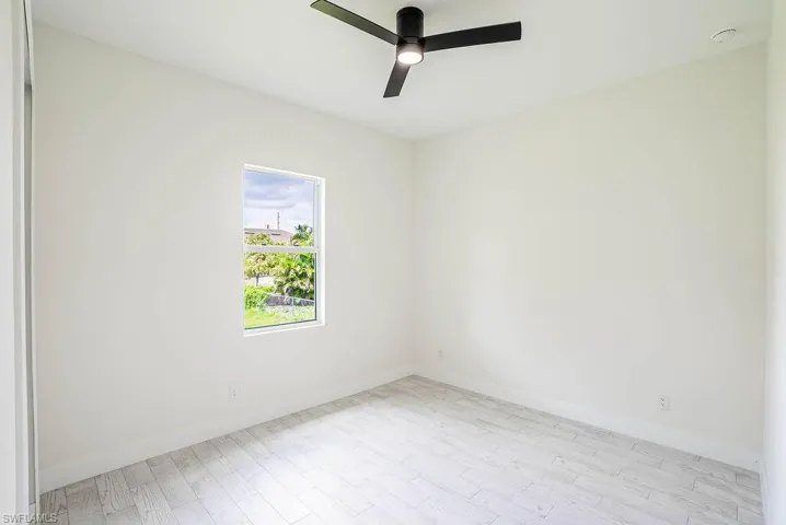 Empty room featuring light wood-type flooring and ceiling fan