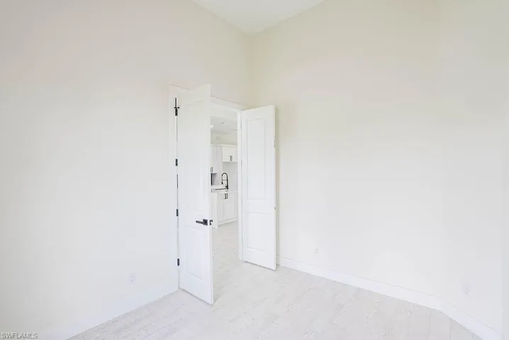 Spare room with sink and light hardwood / wood-style floors