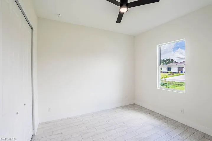 Spare room featuring light hardwood / wood-style floors and ceiling fan