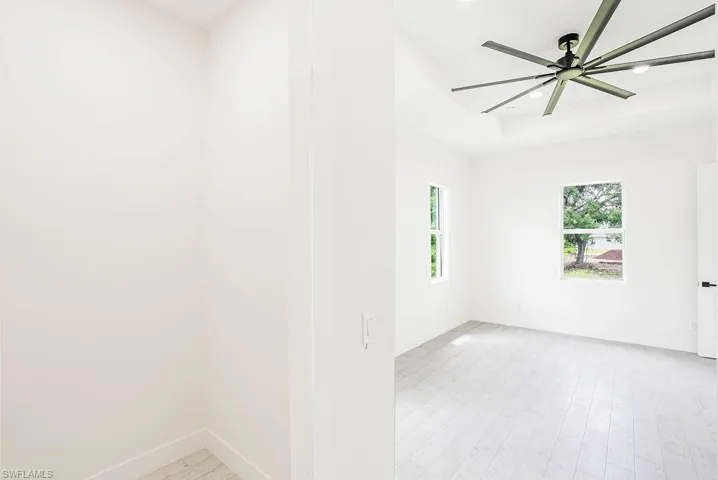 Spare room with light hardwood / wood-style floors and ceiling fan