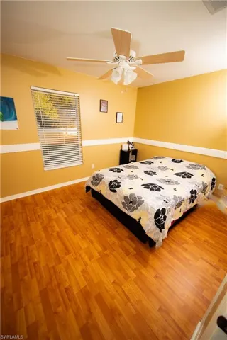 Bedroom with hardwood / wood-style flooring and ceiling fan