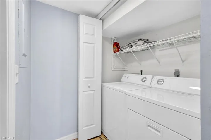 Laundry area with separate washer and dryer and baseboards