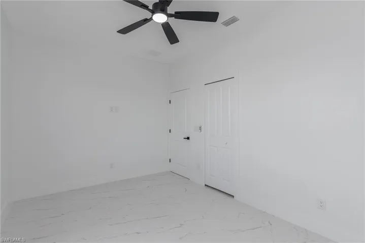 White interior with marble-look tile flooring