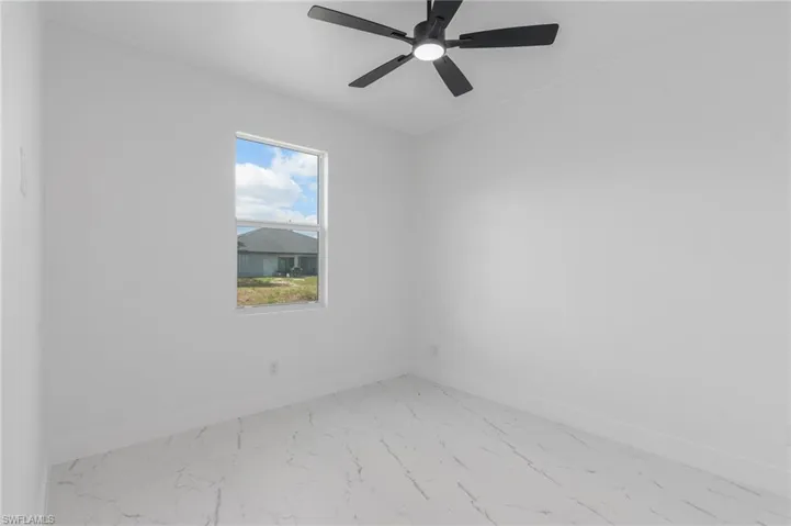 Room featuring white walls, a single window, and a contemporary ceiling fan with integrated lighting