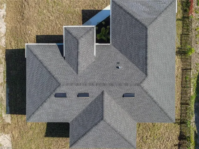 Dark gray architectural shingle roof featuring multiple gables