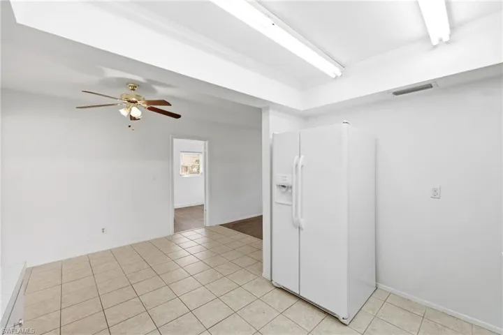 Spare room with ceiling fan and light tile patterned flooring