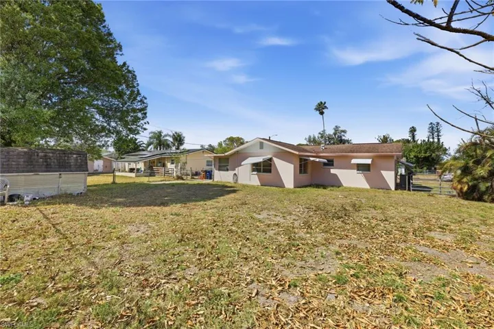 Rear view of house with stucco siding