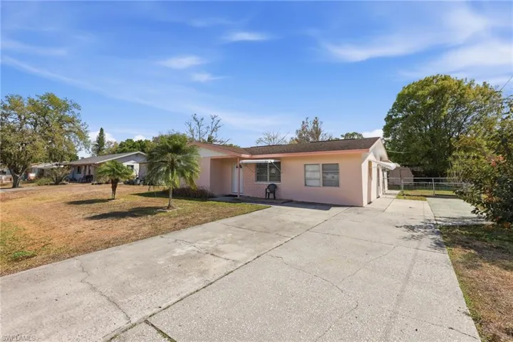 Single story home featuring driveway and stucco siding