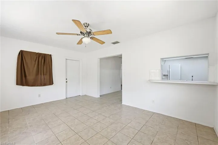 Unfurnished room featuring a ceiling fan and light tile patterned floors