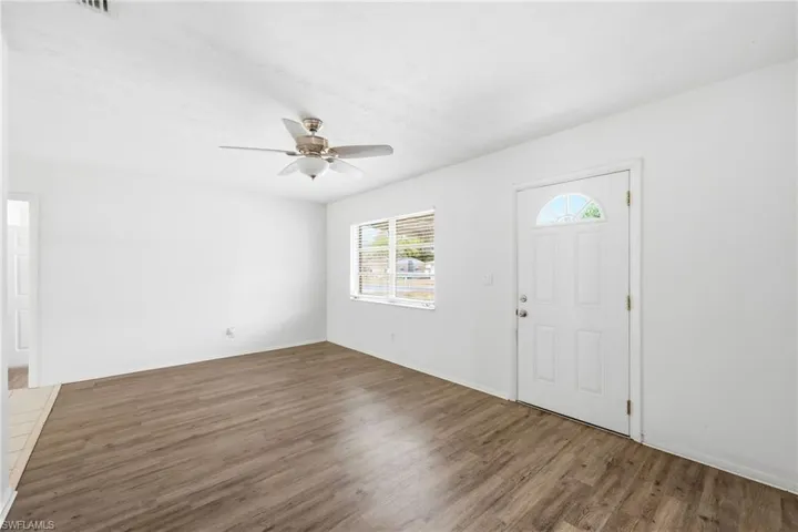 Foyer with a ceiling fan and dark wood finished floors
