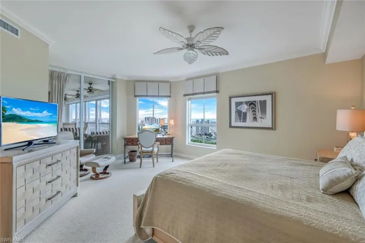 Bedroom featuring ceiling fan, light carpet, and ornamental molding