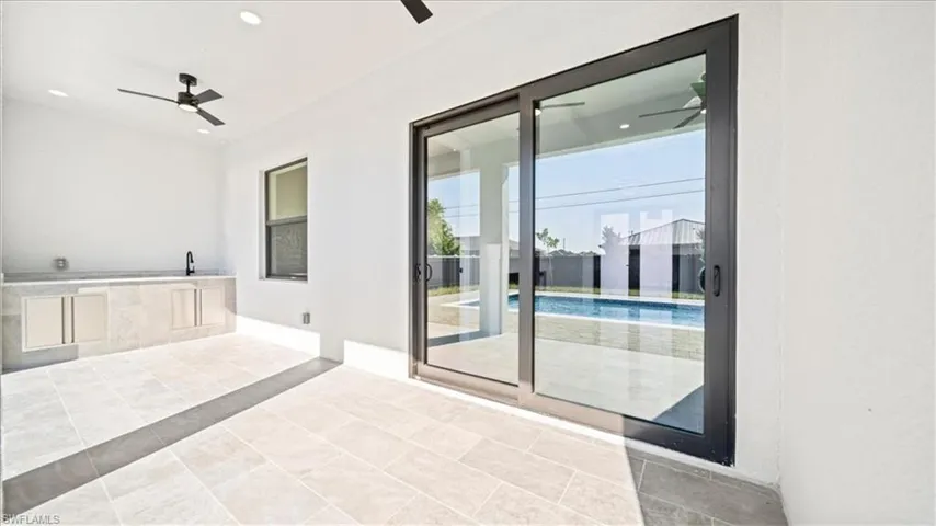 View of patio featuring exterior kitchen and ceiling fan