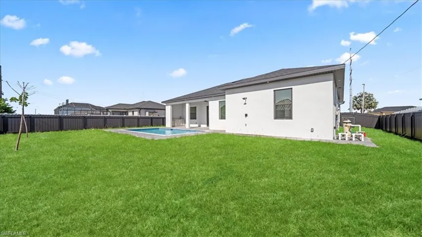Back of house with a patio, a fenced backyard, and stucco siding