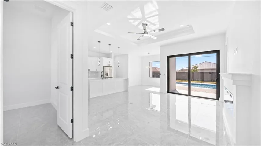 Unfurnished living room featuring ceiling fan and recessed lighting