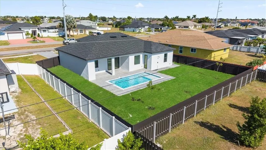 Back of house featuring a patio area, stucco siding, a fenced backyard, and a residential view