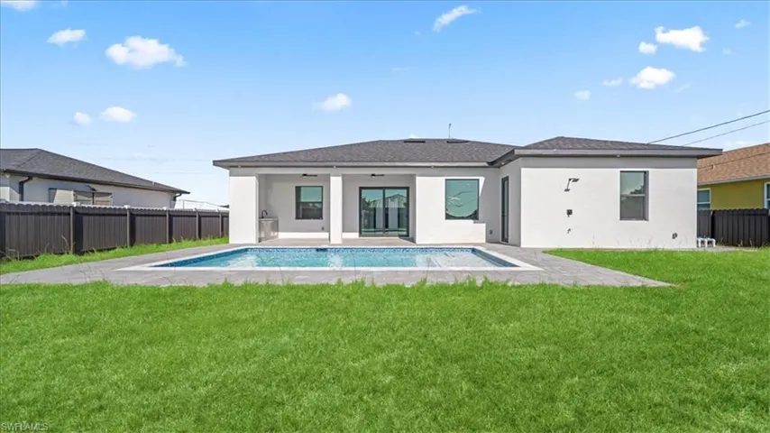Rear view of property with a fenced backyard, a patio area, stucco siding, and a shingled roof