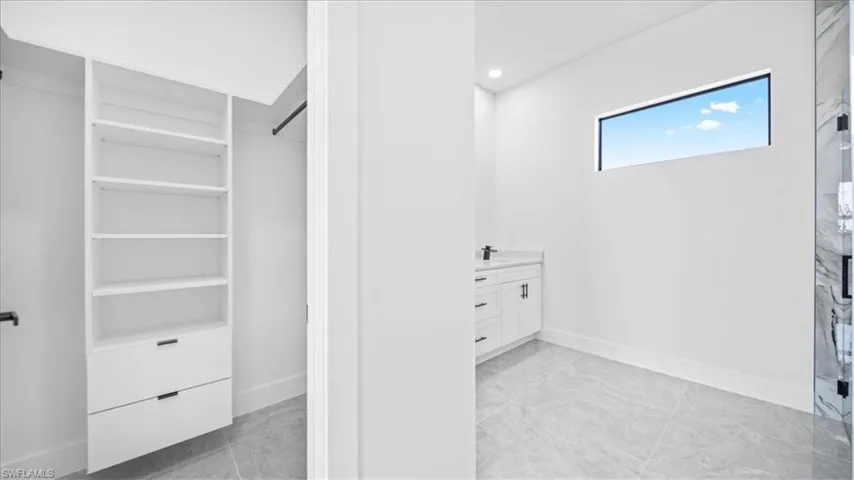 Full bath featuring vanity, recessed lighting, and a shower