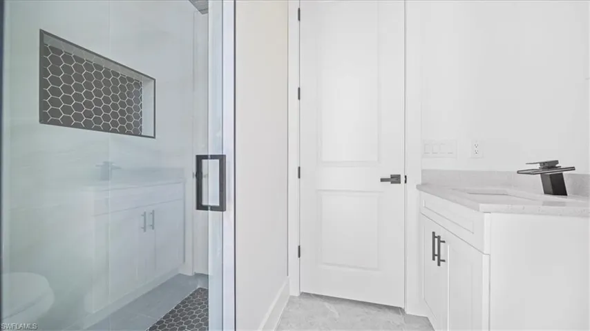 Full bathroom with vanity and a shower