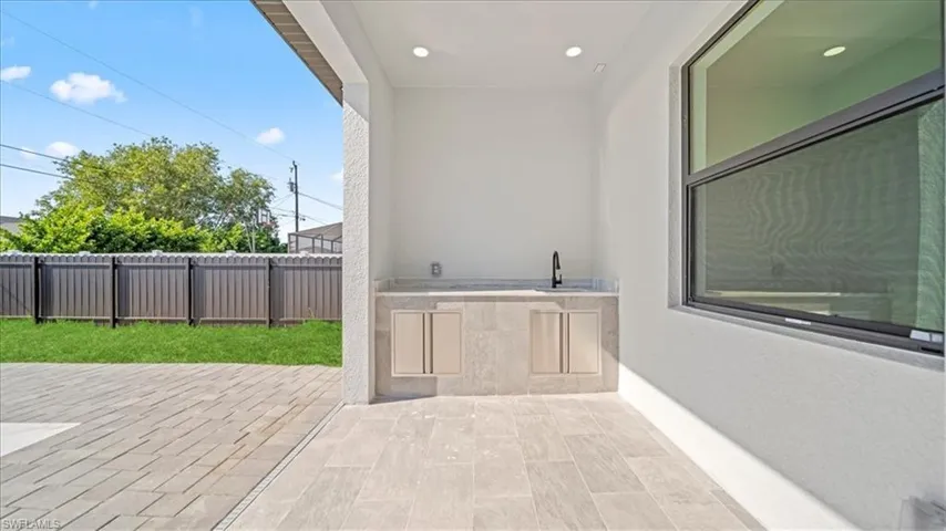 View of patio with area for grilling and a sink