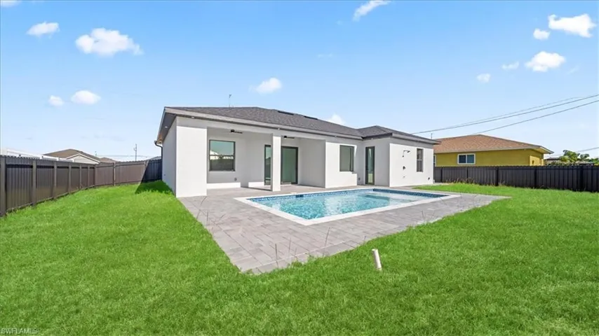 Back of house featuring stucco siding, a patio area, and a fenced backyard