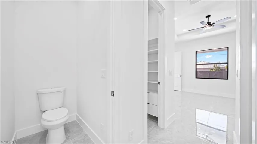 Bathroom with recessed lighting, a ceiling fan, and light tile patterned flooring