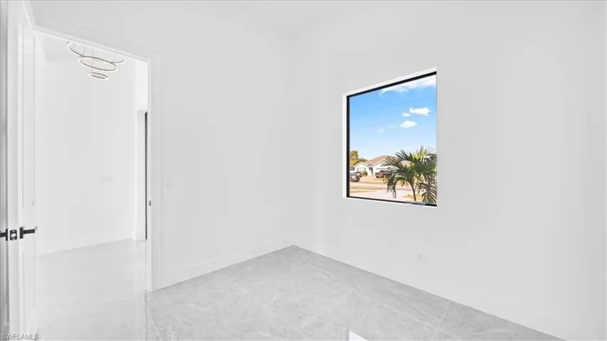 Spare room featuring baseboards