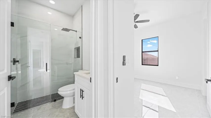 Full bathroom with vanity, a stall shower, recessed lighting, light tile patterned floors, and ceiling fan