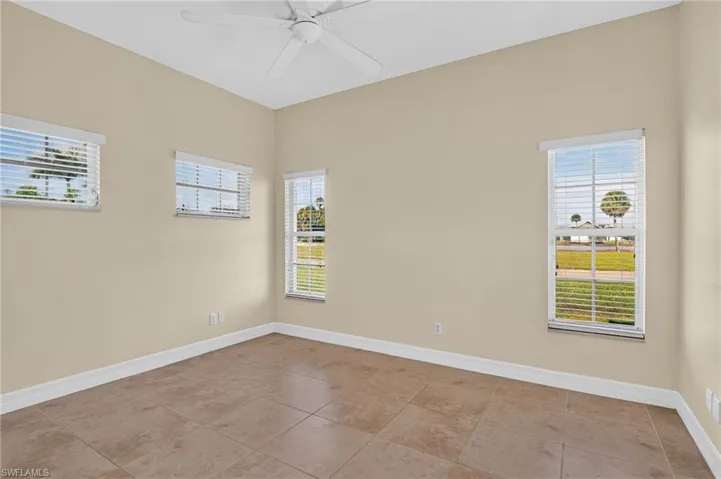 Casita Neutral-toned interior featuring large-format tile flooring, high ceilings, a ceiling fan, and multiple windows with white horizontal blinds