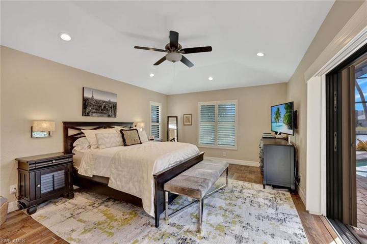 Primary bedroom open to the pool patio.