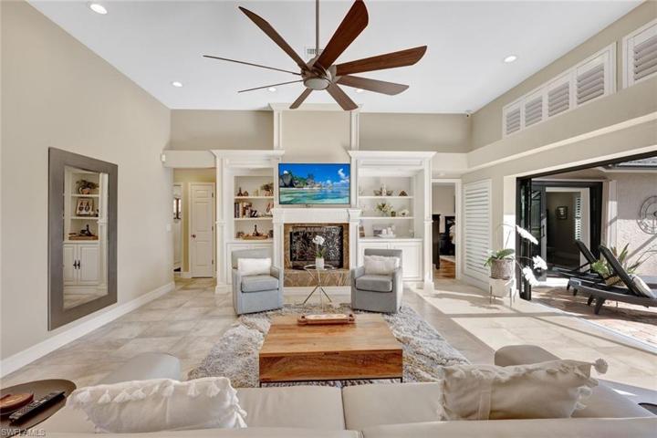 Wood-burning fireplace, complemented by custom, illuminated cases on either side
