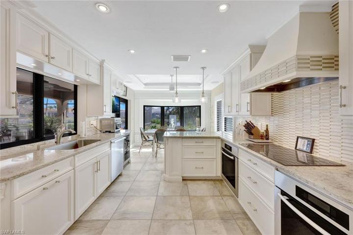 Equipped w/dual Meile full-size ovens, Subzero fridge, wine fridge, microwave, & stylish Café induction five-burner cooktop.