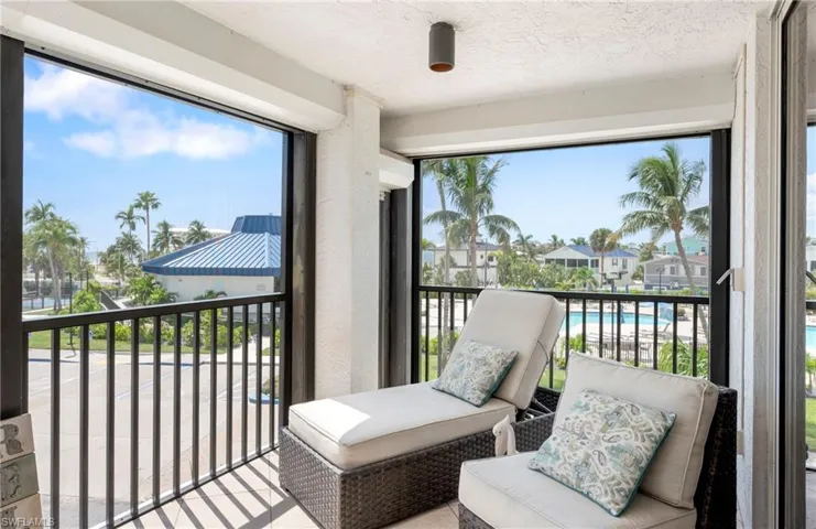 Balcony featuring a sunroom and view of pool
