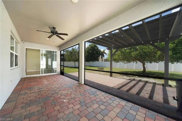 Screened paver patio area and a ceiling fan