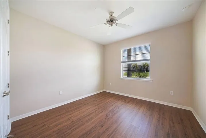 Spare room featuring wood-style flooring and ceiling fan